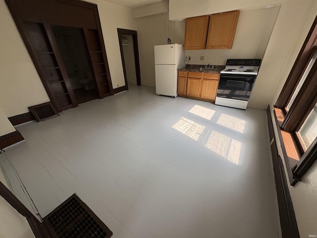 436 W Williams St, Fort Wayne, IN 46802 - kitchen with white appliances, brown cabinetry, and dark countertops