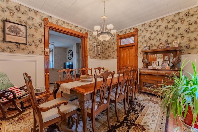 240 Elm St, Wabash, IN 46992 - dining space featuring wallpapered walls, a wainscoted wall, ornamental molding, and a chandelier