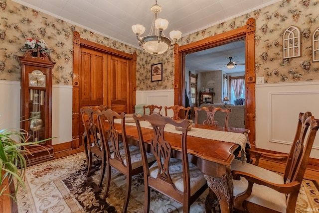 240 Elm St, Wabash, IN 46992 - dining space with wallpapered walls, wainscoting, ornamental molding, wood finished floors, and ceiling fan