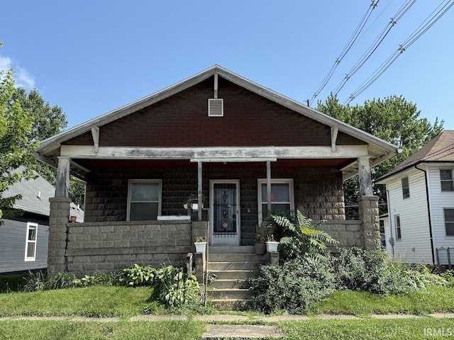 819 Race St, Logansport, IN 46947 - bungalow-style home with covered porch and stone siding