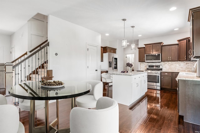3032 Treviso Way, Fort Wayne, IN 46814 - kitchen featuring stainless steel appliances, dark wood finished floors, a center island, decorative backsplash, and recessed lighting