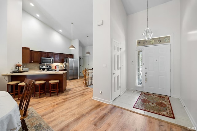 323 E Pine Ave, West Lafayette, IN 47906 - entryway featuring high vaulted ceiling, light wood-style floors, and recessed lighting