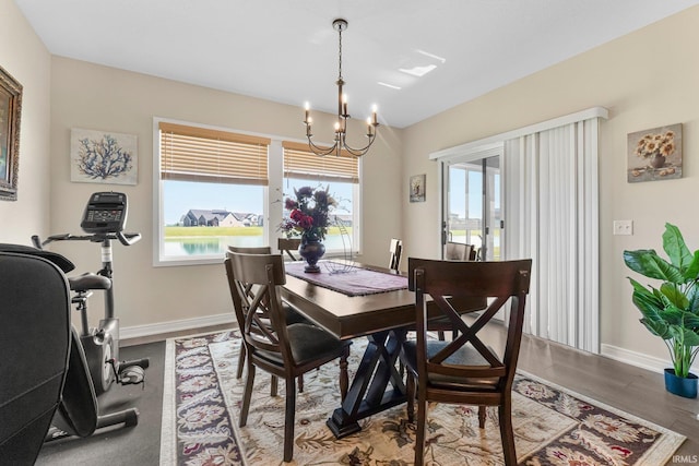 12116 Fazio Dr, Fort Wayne, IN 46818 - dining space with plenty of natural light, a chandelier, and wood finished floors