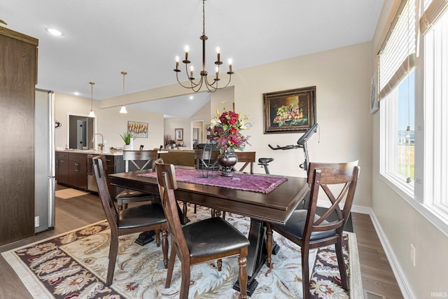 12116 Fazio Dr, Fort Wayne, IN 46818 - dining space featuring healthy amount of natural light, light wood finished floors, a chandelier, recessed lighting, and vaulted ceiling