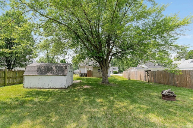 7201 Baer Rd, Fort Wayne, IN 46809 - fenced backyard with a storage shed and an outdoor fire pit