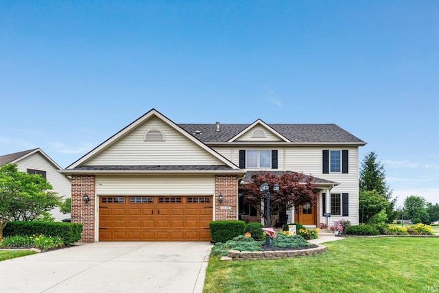2608 Creeping Phlox Cv, Fort Wayne, IN 46818 - traditional home featuring brick siding, a front lawn, concrete driveway, and an attached garage
