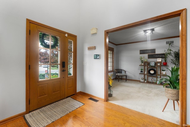 2608 Creeping Phlox Cv, Fort Wayne, IN 46818 - foyer entrance featuring wood finished floors and crown molding