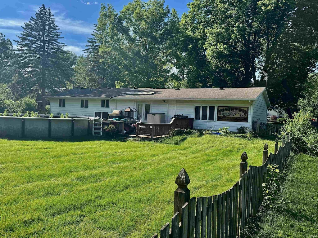 9924 Washington St, Leo, IN 46765 - rear view of house with a wooden deck, a fenced backyard, and a pool