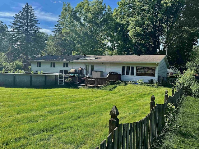 9924 Washington St, Leo, IN 46765 - rear view of house with a wooden deck, a fenced backyard, and a pool