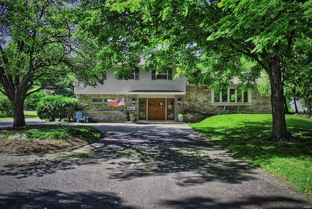 420 E Cedar Canyons Rd, Huntertown, IN 46748 - view of front of home featuring stone siding, driveway, and a front lawn