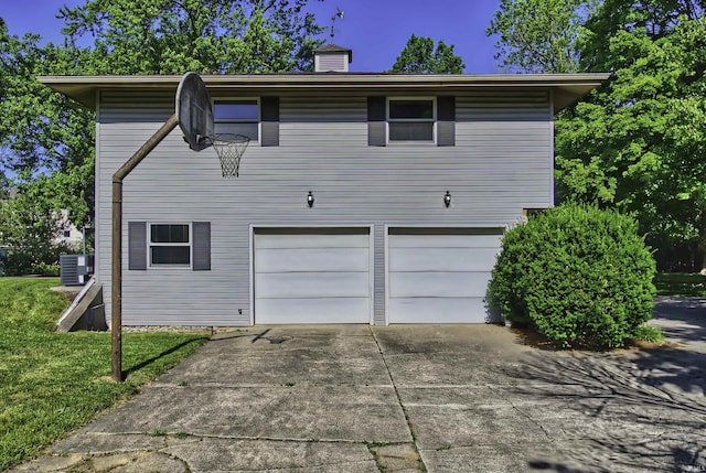 420 E Cedar Canyons Rd, Huntertown, IN 46748 - back of house with a garage, concrete driveway, and a chimney