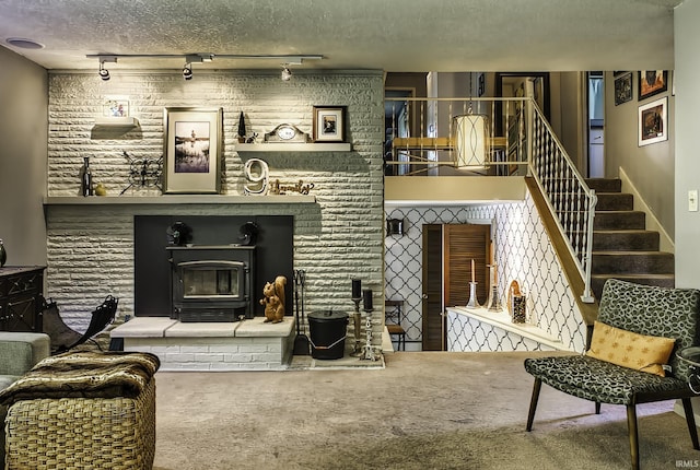 420 E Cedar Canyons Rd, Huntertown, IN 46748 - living room with track lighting, carpet flooring, a glass covered fireplace, stairs, and a textured ceiling