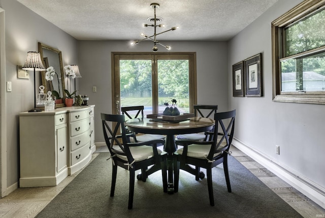 420 E Cedar Canyons Rd, Huntertown, IN 46748 - dining space with light wood-style floors, a textured ceiling, healthy amount of natural light, and a chandelier