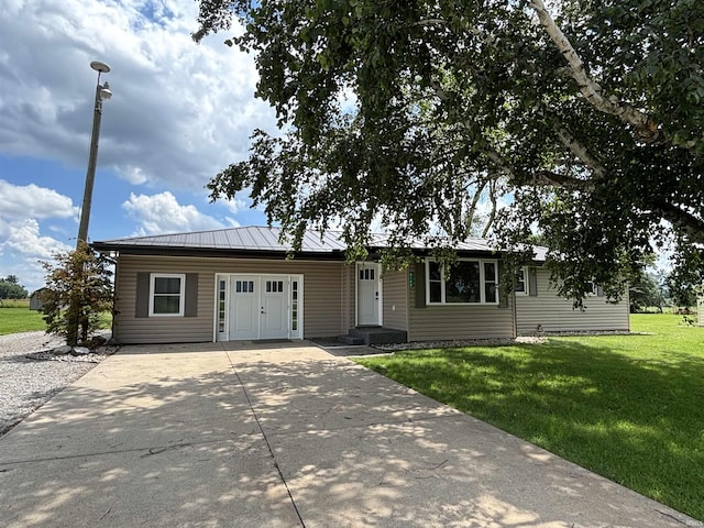 140 W 100 S Rd, Lagrange, IN 46761 - ranch-style home with concrete driveway, a front yard, and a metal roof