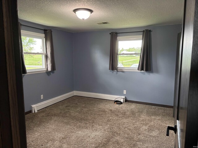 140 W 100 S Rd, Lagrange, IN 46761 - empty room with a textured ceiling, carpet flooring, and baseboard heating