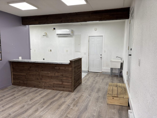 140 W 100 S Rd, Lagrange, IN 46761 - kitchen featuring a wall mounted air conditioner, wood finished floors, a peninsula, beam ceiling, and electric panel