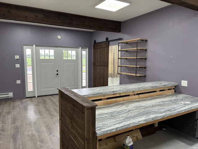 140 W 100 S Rd, Lagrange, IN 46761 - interior space featuring beam ceiling, light wood-style floors, baseboard heating, and a barn door