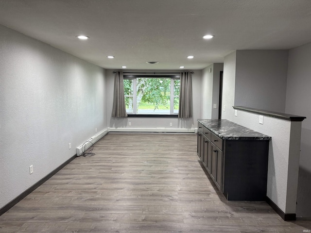 140 W 100 S Rd, Lagrange, IN 46761 - empty room featuring a baseboard radiator, recessed lighting, wood finished floors, and a textured wall