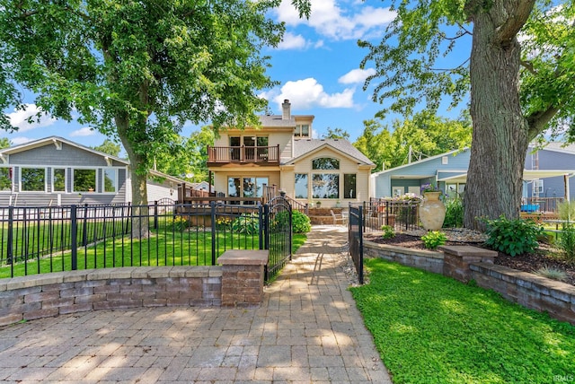 2624 E Stalf Rd, Columbia City, IN 46725 - view of front facade with a gate, a balcony, a fenced front yard, and a chimney