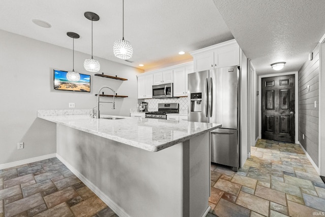 2624 E Stalf Rd, Columbia City, IN 46725 - kitchen featuring stainless steel appliances, stone tile flooring, open shelves, a peninsula, and white cabinets