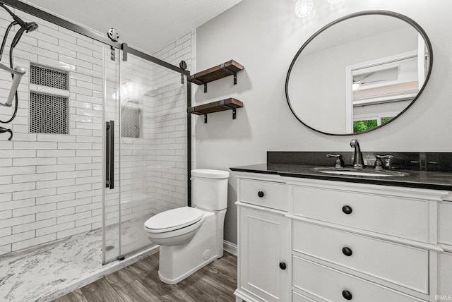 2624 E Stalf Rd, Columbia City, IN 46725 - bathroom with vanity, wood finished floors, and a stall shower