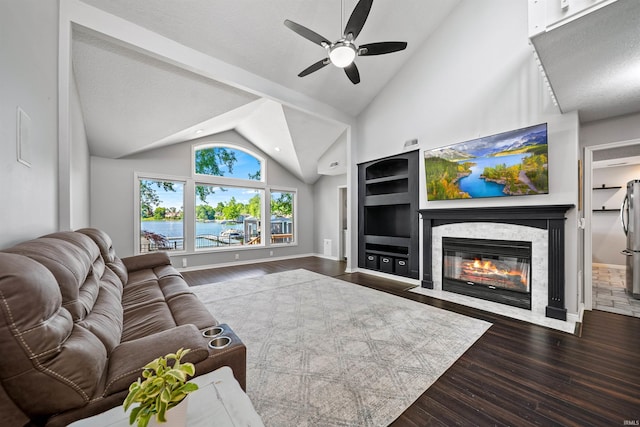 2624 E Stalf Rd, Columbia City, IN 46725 - living area featuring wood finished floors, vaulted ceiling, ceiling fan, and a fireplace with flush hearth