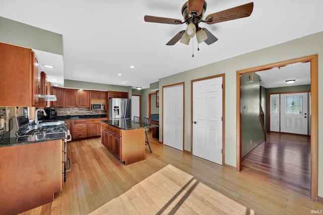 20860 Wyngate Court 20860Wyngate Ct S Bend, In 46614-5178, South Bend, IN 46614 - kitchen featuring stainless steel appliances, a kitchen bar, light wood-type flooring, decorative backsplash, and a center island
