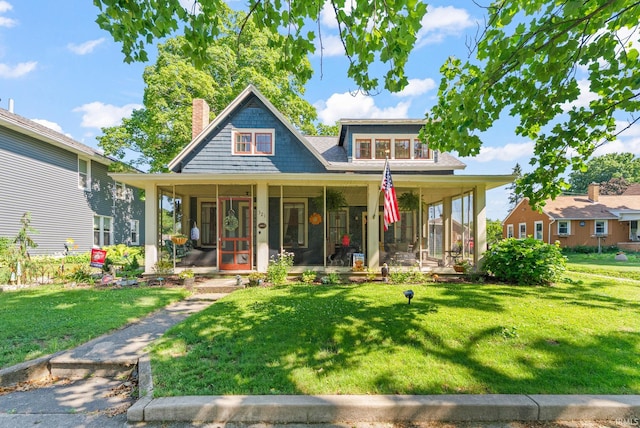 321 W Michigan St, New Carlisle, IN 46552 - view of front of property with a front lawn, a chimney, and covered porch