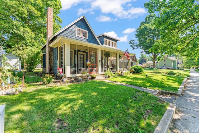 321 W Michigan St, New Carlisle, IN 46552 - view of front facade with a chimney, a front lawn, a porch, and a sunroom