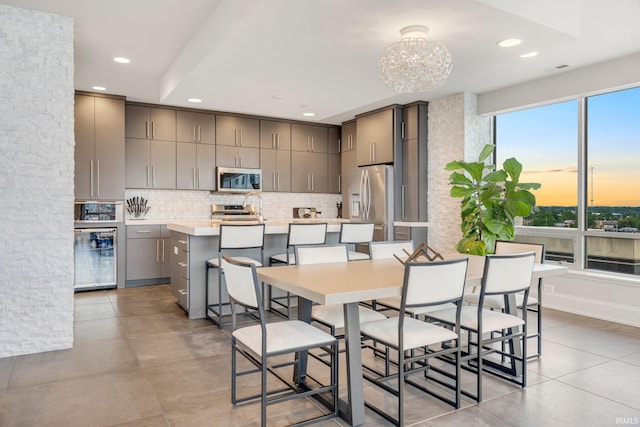 203 E Berry St Unit 1004, Fort Wayne, IN 46802 - dining room featuring a chandelier, recessed lighting, beverage cooler, and light tile patterned floors