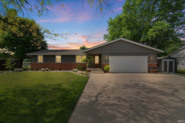 604 W 2nd St, Fowler, IN 47944 - ranch-style house with brick siding, a lawn, driveway, and a storage unit