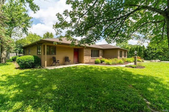 3836 W State Blvd, Fort Wayne, IN 46808 - back of house with a yard, a patio area, and brick siding