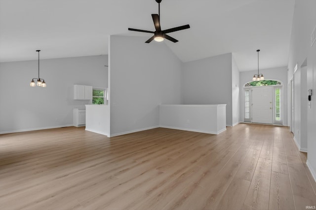 50588 Carrington Place Dr, South Bend, IN 46637 - unfurnished living room featuring a chandelier, plenty of natural light, light wood-style floors, a ceiling fan, and high vaulted ceiling