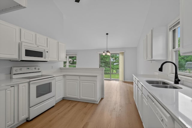 50588 Carrington Place Dr, South Bend, IN 46637 - kitchen with white appliances, light countertops, white cabinets, healthy amount of natural light, and high vaulted ceiling