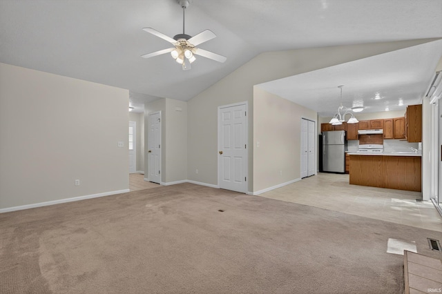 51613 Emmons Rd, South Bend, IN 46637 - unfurnished living room featuring light colored carpet, vaulted ceiling, a ceiling fan, and a chandelier
