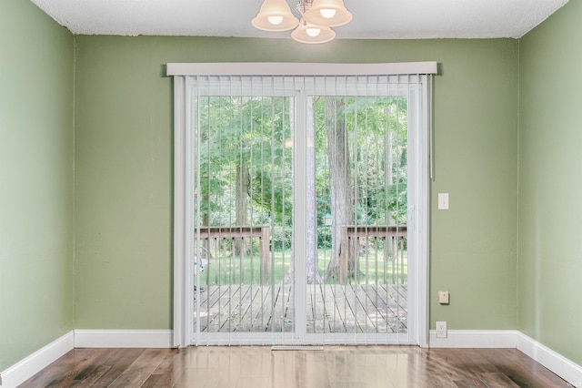 4648 Parkerdale Dr, Fort Wayne, IN 46815 - doorway to outside featuring a chandelier and wood finished floors