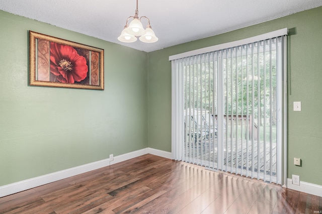 4648 Parkerdale Dr, Fort Wayne, IN 46815 - unfurnished room featuring a chandelier, plenty of natural light, and wood finished floors