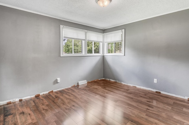 4648 Parkerdale Dr, Fort Wayne, IN 46815 - spare room with a textured ceiling, wood finished floors, and ornamental molding