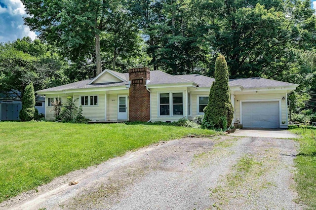 4648 Parkerdale Dr, Fort Wayne, IN 46815 - ranch-style house featuring driveway, a chimney, an attached garage, a front lawn, and view of wooded area