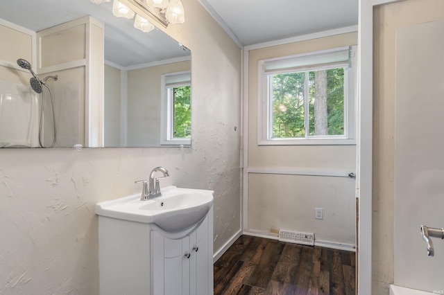 4648 Parkerdale Dr, Fort Wayne, IN 46815 - bathroom with vanity, healthy amount of natural light, wood finished floors, and crown molding