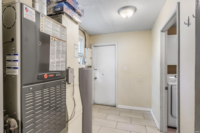 4648 Parkerdale Dr, Fort Wayne, IN 46815 - laundry room featuring heating unit, a textured ceiling, and washer / clothes dryer