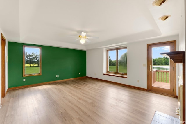 6625 Union Chapel Rd, Fort Wayne, IN 46845 - spare room featuring a raised ceiling, light wood-style flooring, and a ceiling fan