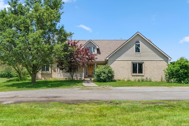6625 Union Chapel Rd, Fort Wayne, IN 46845 - view of front of home with brick siding, a front yard, and covered porch