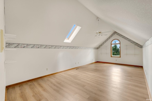 6625 Union Chapel Rd, Fort Wayne, IN 46845 - additional living space featuring a skylight, light wood-style flooring, a ceiling fan, vaulted ceiling, and a textured ceiling