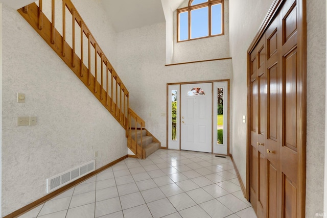 6625 Union Chapel Rd, Fort Wayne, IN 46845 - foyer with a high ceiling, stairway, and light tile patterned floors