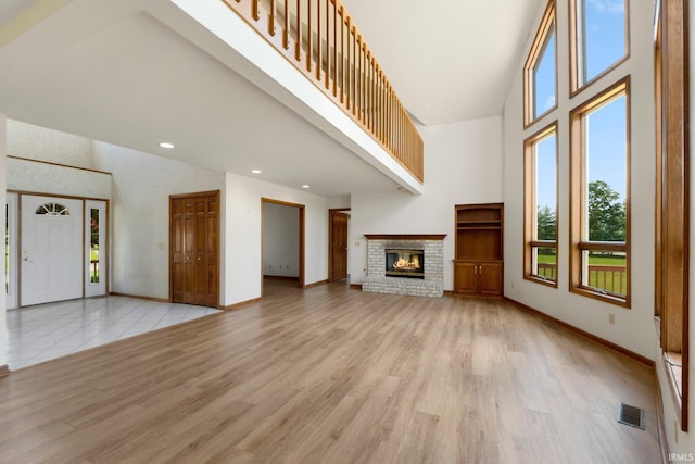 6625 Union Chapel Rd, Fort Wayne, IN 46845 - unfurnished living room with high vaulted ceiling, light wood finished floors, a fireplace, and recessed lighting