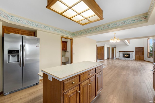6625 Union Chapel Rd, Fort Wayne, IN 46845 - kitchen featuring stainless steel fridge with ice dispenser, brown cabinetry, a chandelier, and light wood-style flooring
