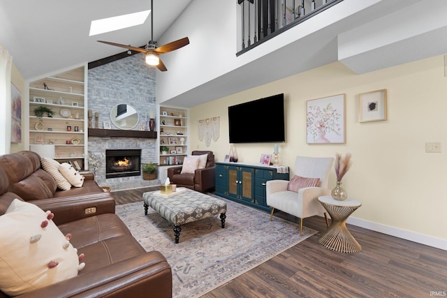 10729 Lone Tree Pl, Fort Wayne, IN 46818 - living room with a skylight, wood finished floors, a ceiling fan, built in shelves, and a fireplace