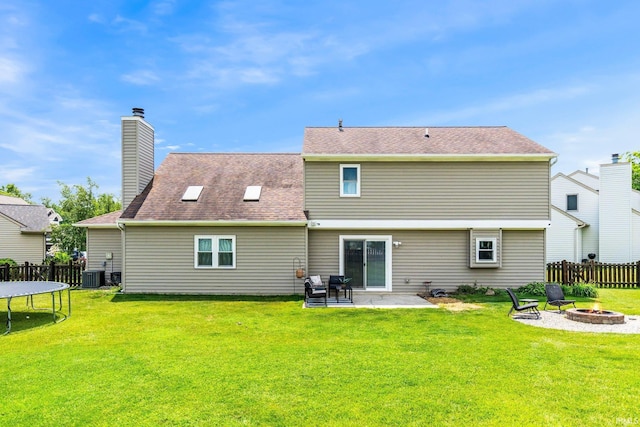 10729 Lone Tree Pl, Fort Wayne, IN 46818 - rear view of house with an outdoor fire pit, a trampoline, a patio, a chimney, and a shingled roof
