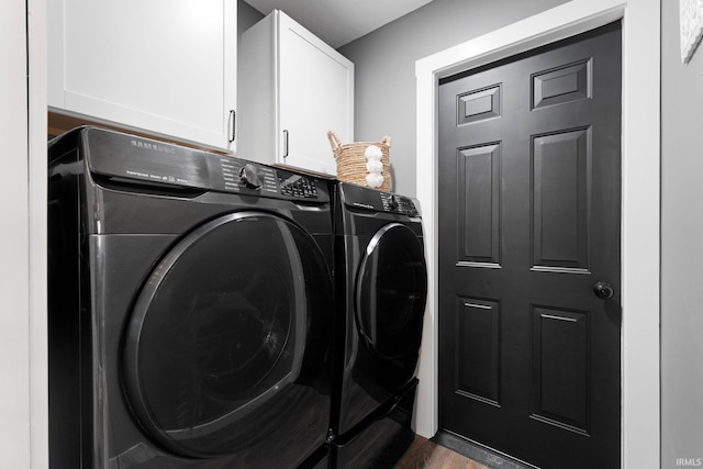 10729 Lone Tree Pl, Fort Wayne, IN 46818 - laundry room featuring independent washer and dryer, cabinet space, and dark wood-type flooring